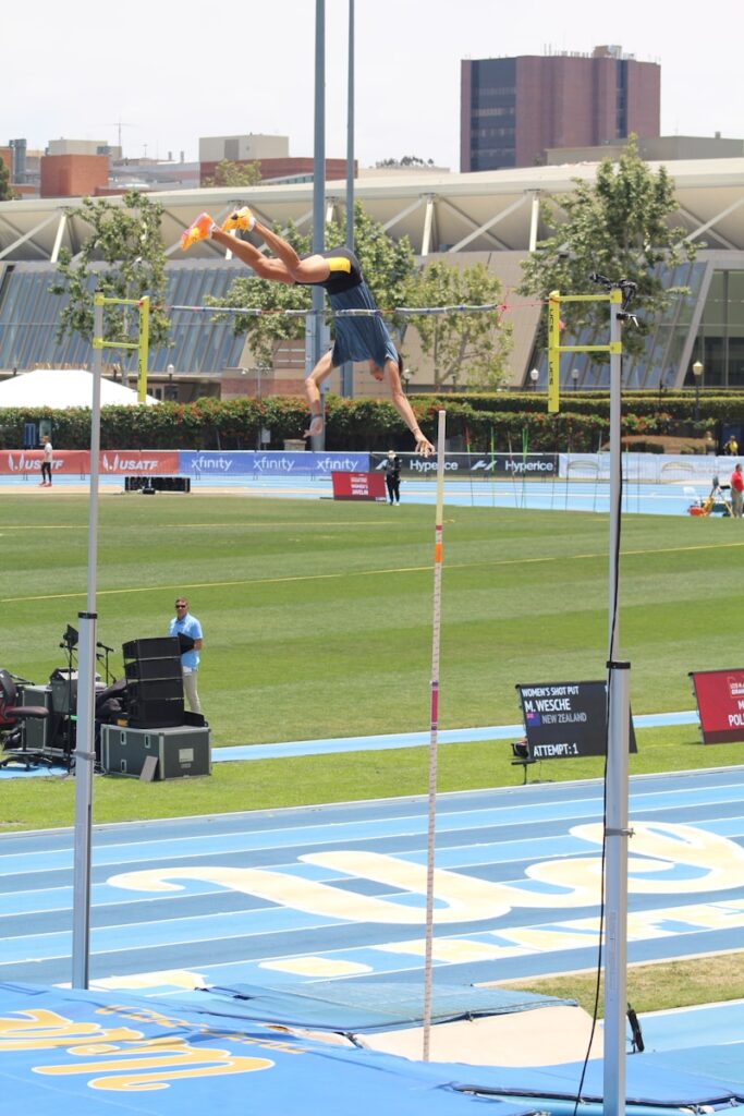 a man jumping in the air on a track